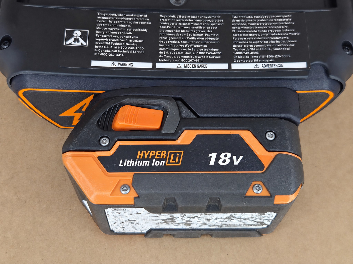 RIDGID AEG 18V Adflo adapter - underside warning labels with RIDGID Hyper pack latched in - bottom view